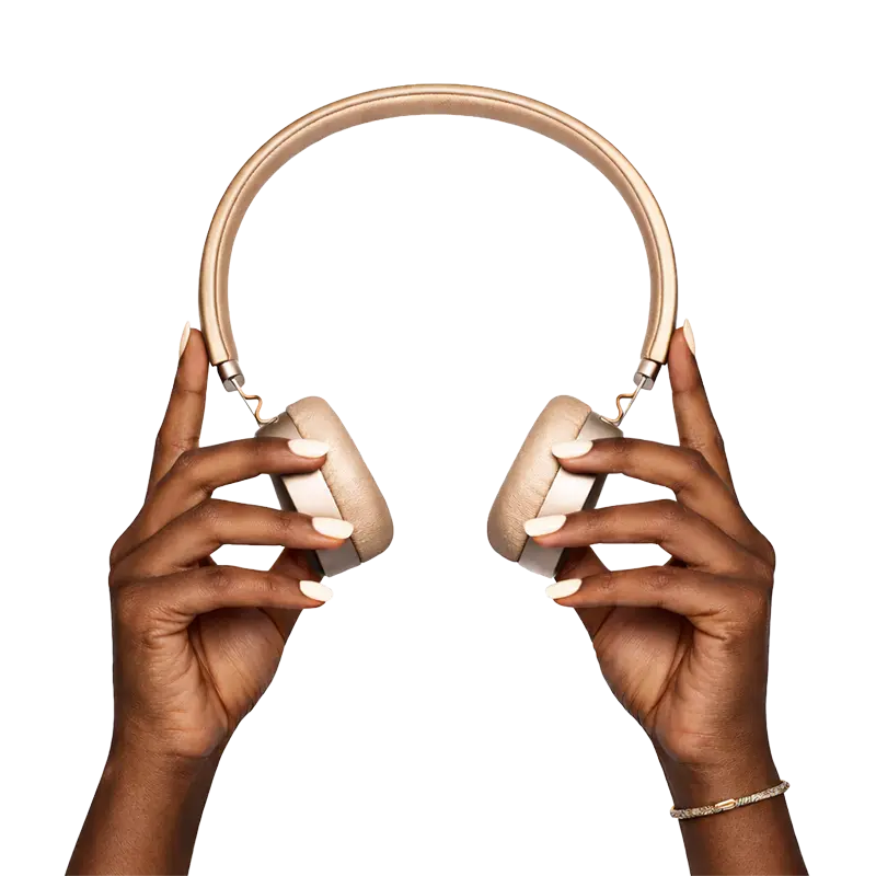 Dark-skinned hands holding elegant over-ear headphones in an intimate, audio-first moment
