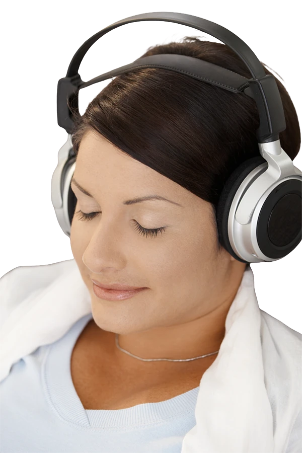 Woman wearing over-ear headphones with eyes closed, representing relaxation, calm, and slow sensory exploration.

