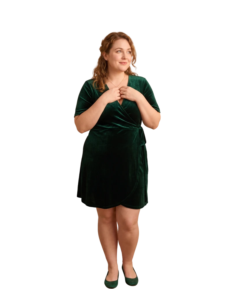Woman in an emerald velvet wrap dress with hands clasped warmly at her chest, smiling softly — Romantic vibe quiz result hero